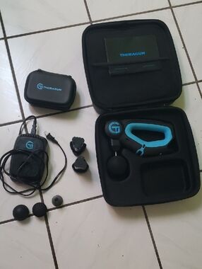 In great condition "Theragun" Massage Gun in Black & Teal with Case